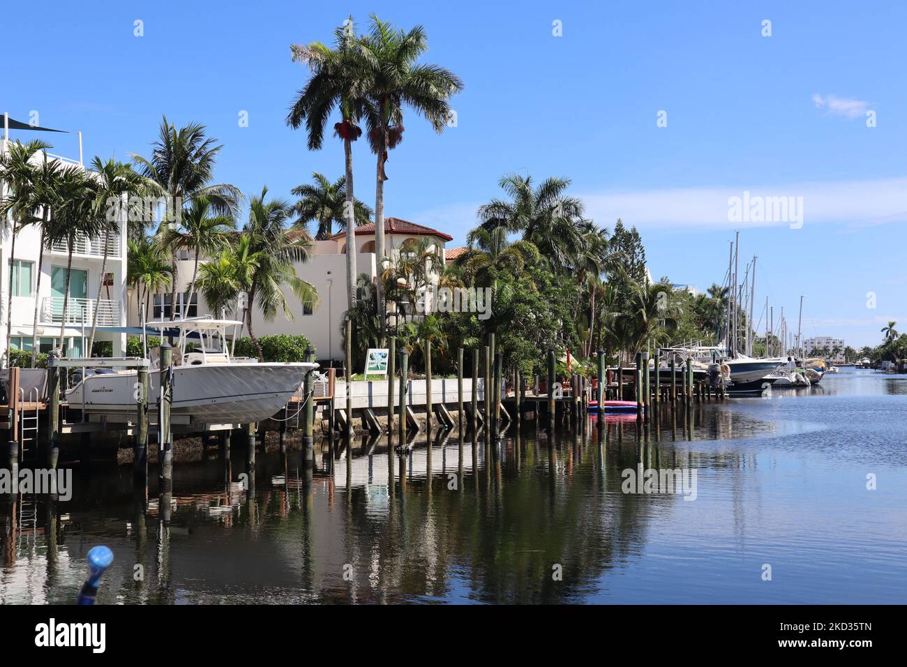 A beautiful landscape view of a canal waterway with luxury homes and