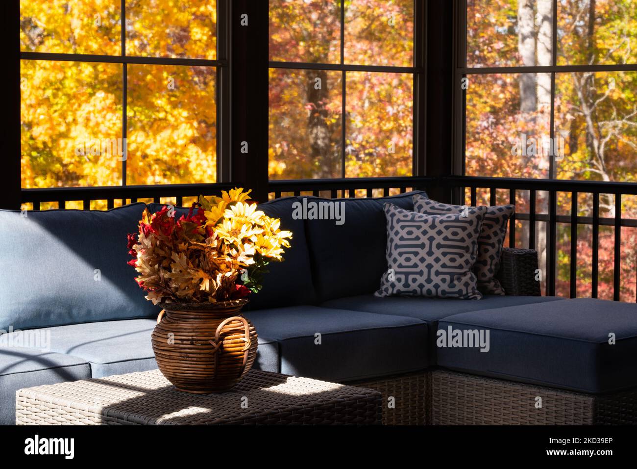 Cozy screened porch enclosure view in autumn. Flower bouquet in a vase