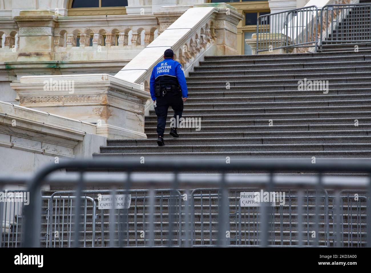 A U.S. Capitol Police officer walks the steps of the West Front of the Capitol building on February 22, 2022, ahead of President Biden's State of the Union address and multiple anti-vaccine mandate truck convoys arriving in the city in coming days (Photo by Bryan Olin Dozier/NurPhoto) Stock Photo