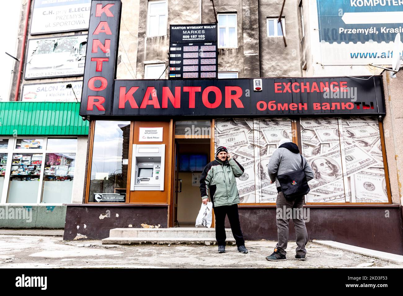 Men stand in front of an exchange office as prices Ukrainian Hryvna were priced unfavourably after Russia invaded neighbouring Ukraine - Przemysl, Poland on February 25, 2022. As the Russian Federation army crossed Ukrainian borders the conflict between Ukraine and Russian is expected to force up 5 million Ukrainians to flee. Most of refugees will seek asylum in Poland. Most escapees arrived to border towns like Przemysl and relocate to inner cities. (Photo by Dominika Zarzycka/NurPhoto) Stock Photo