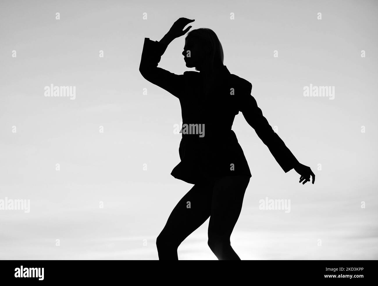Dancing silhouette of dance girl woman dancer in dusk silhouetted on