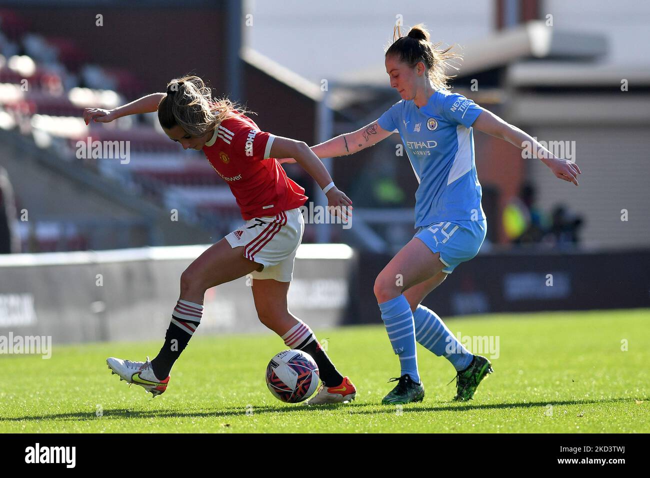 Ella Toone of Manchester United Women Football Club tussles with Keira