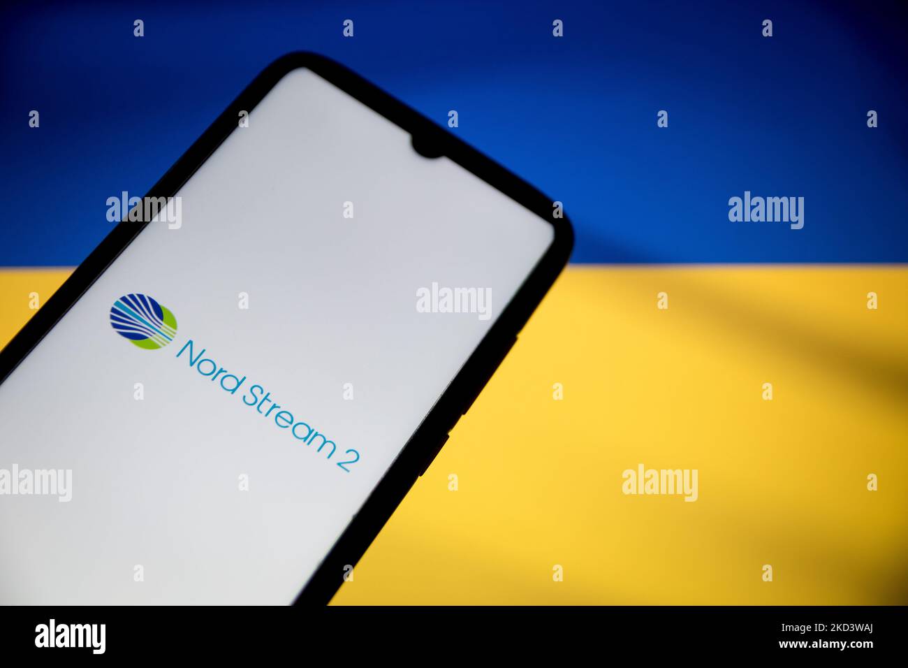In this photo illustration a North Steam 2 logo seen displayed on a smartphone screen with a flag of Ukraine in the background in Athens, Greece on February 28, 2022. (Photo illustration by Nikolas Kokovlis/NurPhoto) Stock Photo
