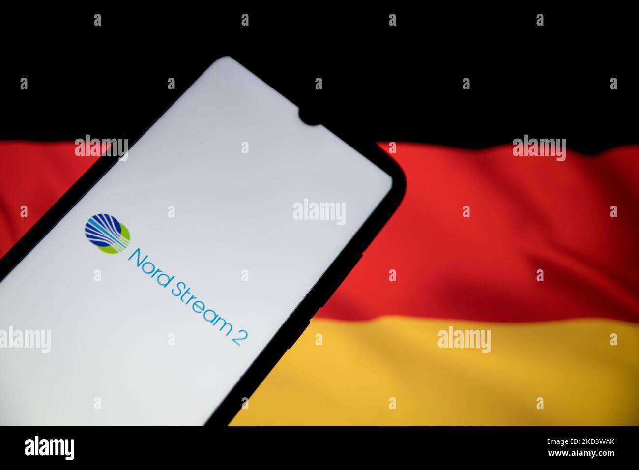 In this photo illustration a North Steam 2 logo seen displayed on a smartphone screen with a flag of Germany in the background in Athens, Greece on February 28, 2022. (Photo illustration by Nikolas Kokovlis/NurPhoto) Stock Photo