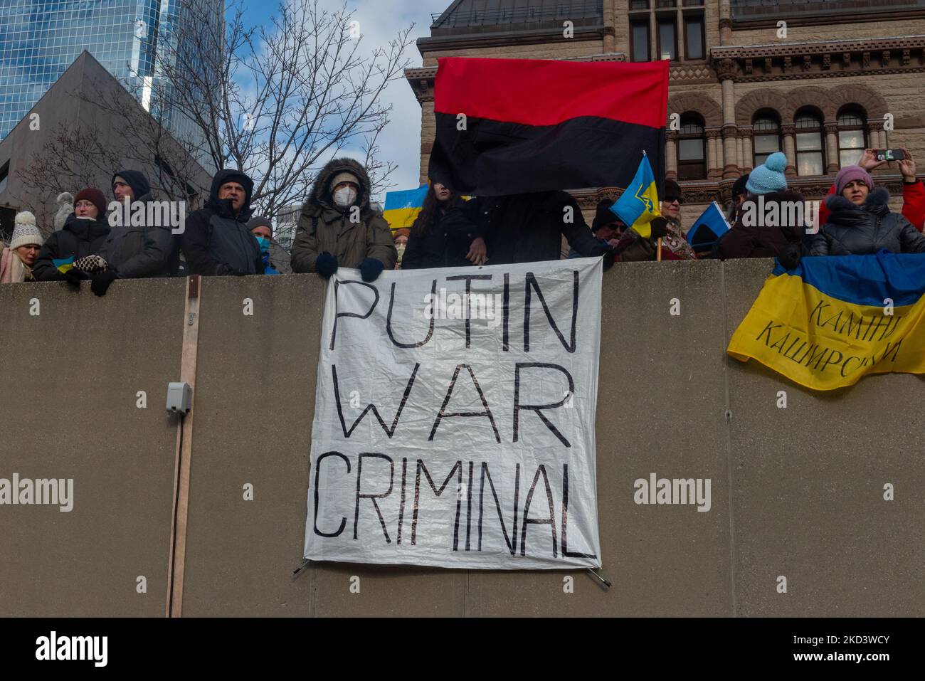 Demonstrators with yellow and blue Ukraine flags and anti-war signs in ...