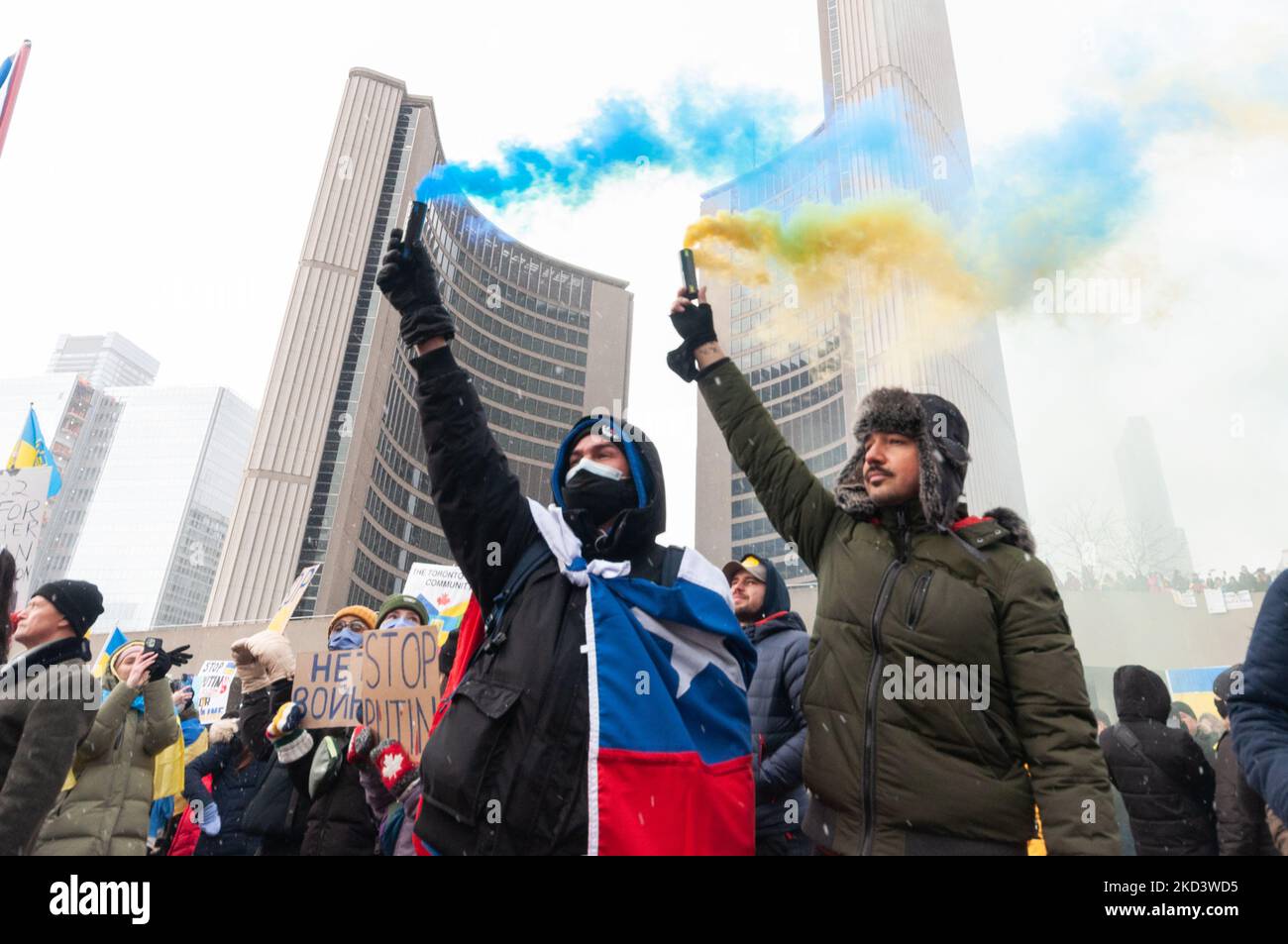 Demonstrators with yellow and blue Ukraine flags and anti-war signs in Downtown Nathan Phillips Square during a demonstration against Russian invasion in Ukraine. (Photo by Anatoliy Cherkasov/NurPhoto) Stock Photo