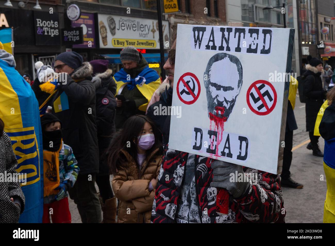 Demonstrators with yellow and blue Ukraine flags and anti-war signs in ...