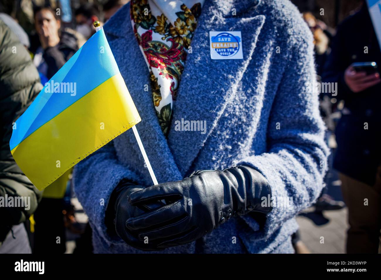 A demonstrator holds a Ukrainian flag at Washington Square Park Sunday February 27, 2022 in New York, NY. Earlier today, Vladimir Putin announced that nuclear forces would be put on high alert in response to aggressive statements made by leading NATO powers. (Erin Lefevre/NurPhoto) (Photo by Erin Lefevre/NurPhoto) Stock Photo