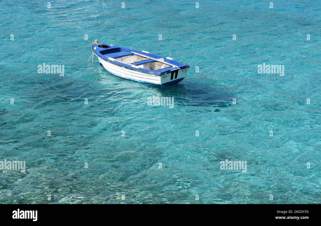 An aerial view of a small boat in a shallow blue sea Stock Photo - Alamy