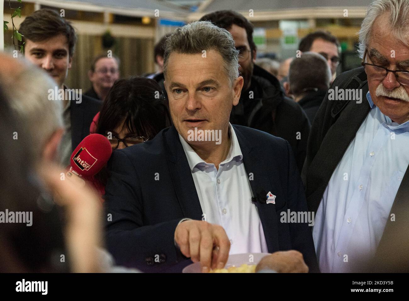 Fabien Roussel, candidate for the French Communist Party (PCF) in the French presidential election, talks with a cheese exhibitor during the traditional visit of the presidential candidates to the International Agricultural Show currently being held at the Parc des Exposition de la Porte de Versailles in Paris on February 28, 2022. (Photo by Samuel Boivin/NurPhoto) Stock Photo