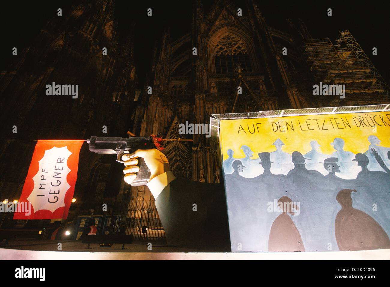 a Carnival float featuring vaccine skeptics flagi is illuminated in the city center of Cologne, Germany on Feb 28, 2022 during the tradition carnival Rose monday procession which was cancelled due to Ukraine war (Photo by Ying Tang/NurPhoto) Stock Photo