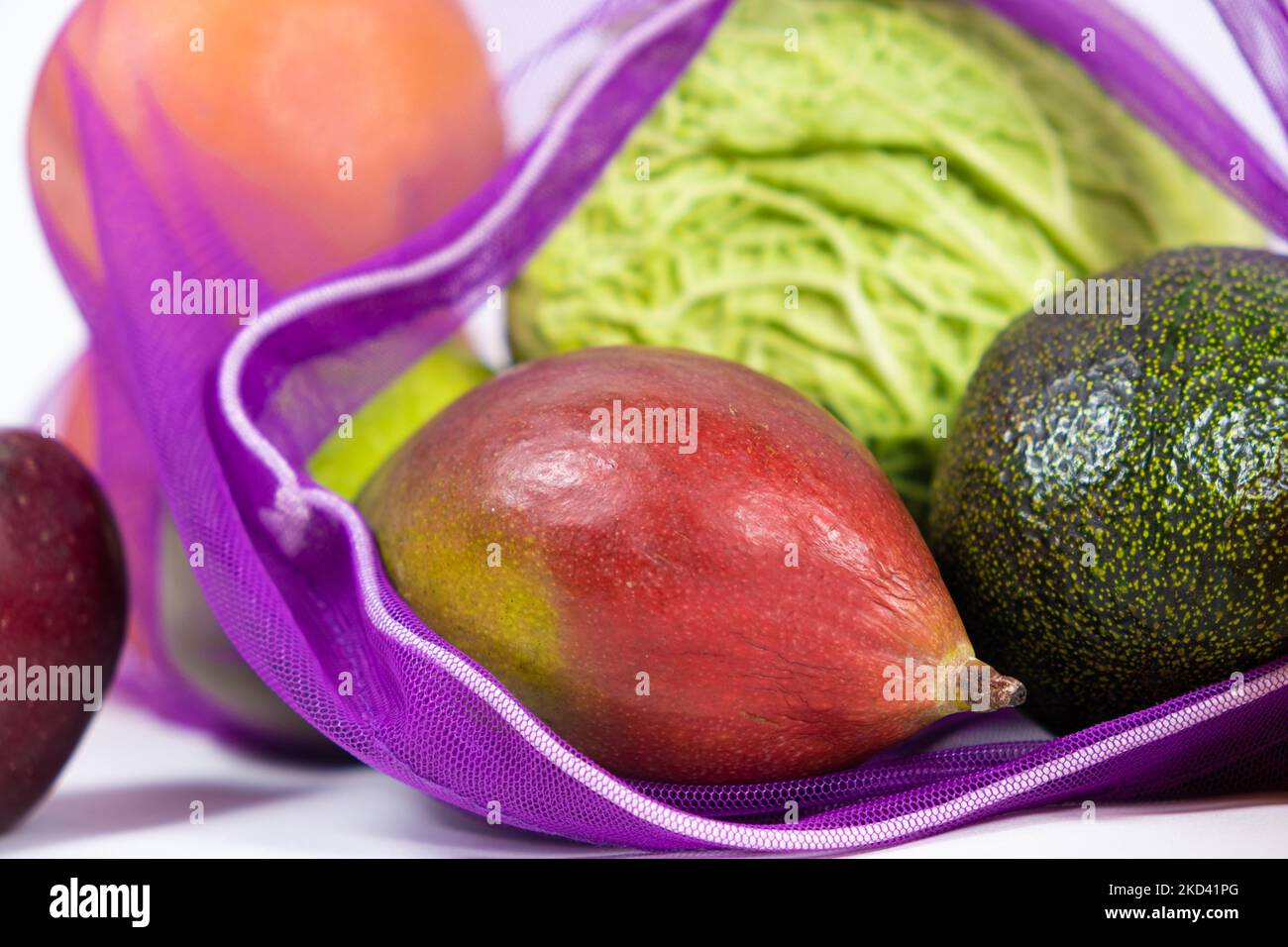 Fabric mesh for fruits and vegetables on a white background. A reusable