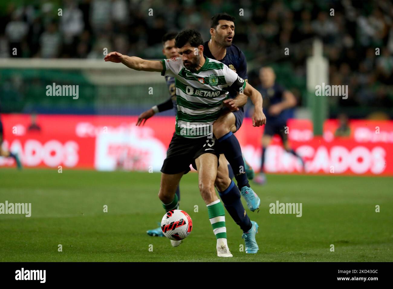 Luis Neto of Sporting CP (L) fights for the ball with Mehdi Taremi of FC Porto during the Portugal Cup semi-final first leg football match between Sporting CP and FC Porto at the Jose Alvalade stadium in Lisbon, Portugal on March 2, 2022. (Photo by Pedro FiÃºza/NurPhoto) Stock Photo