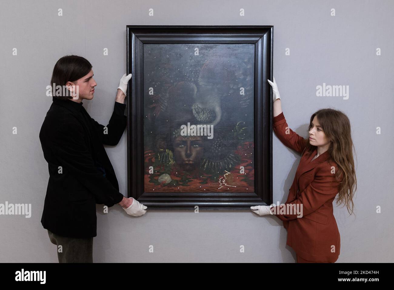 LONDON, UNITED KINGDOM - MARCH 04, 2022: Staff members hold 'Portrait d'Arthur Rimbaud' (Painted in 1933) by Valentine Hugo (1887-1968), estimate: £400,000 - 600,000 during a photo call for The Mind’s Eye: Surrealist Sale at Bonhams auction house on March 04, 2022 in London, England. (Photo by WIktor Szymanowicz/NurPhoto) Stock Photo