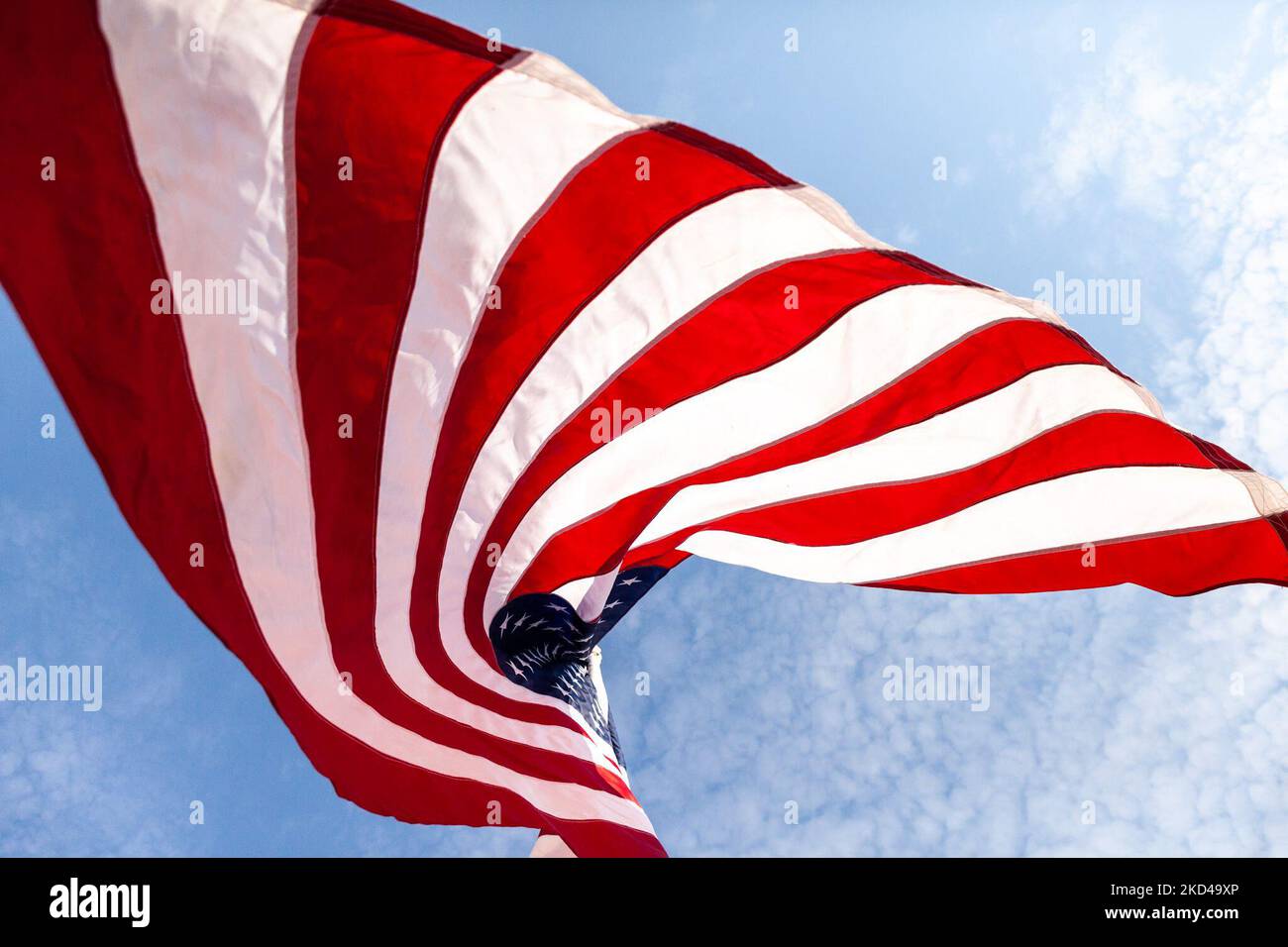 An American flag fliesduring a rally against white nationalism hosted by military veteran organizations Continue to Serve and Common Defense. Organizers held the rally to counter messaging from some in the trucker convoy near Washington. (Photo by Allison Bailey/NurPhoto) Stock Photo