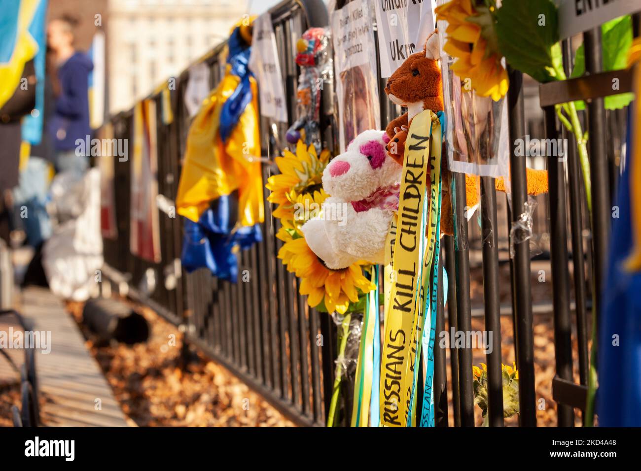 Toys, flowers, and memorials to children killed in Ukraine hang on a fence during a rally White House. This is reminiscent of how the now-famous Black Lives Memorial Fence began. Hundreds of people gathered to demand a NATO no-fly zone and military assistance for Ukraine. This is the 10th consecutive day of demonstrations at the White House for Ukraine. (Photo by Allison Bailey/NurPhoto) Stock Photo