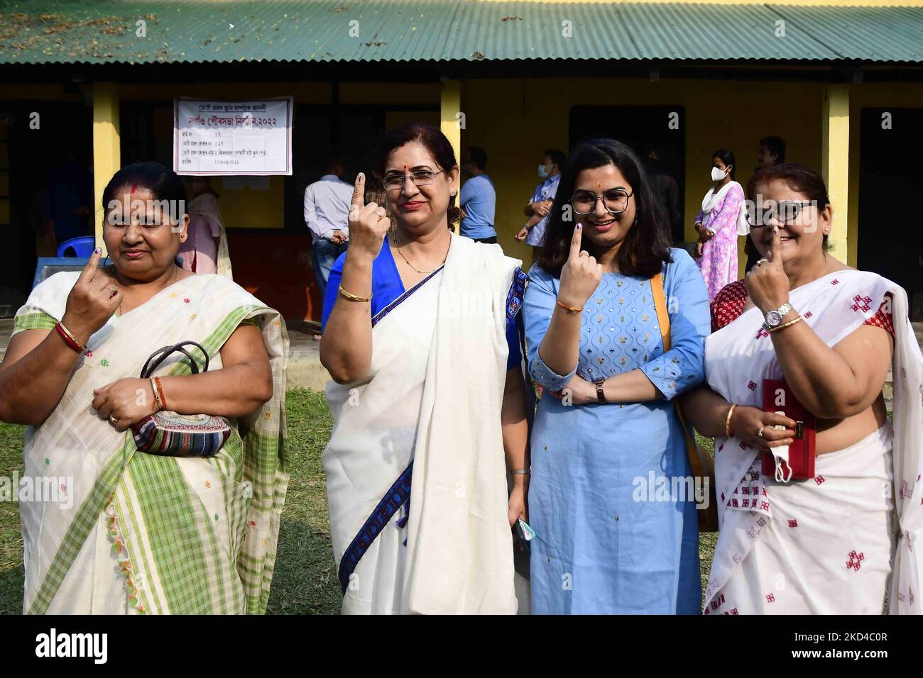 Women show their fingers marked with indelible ink after casting their ...
