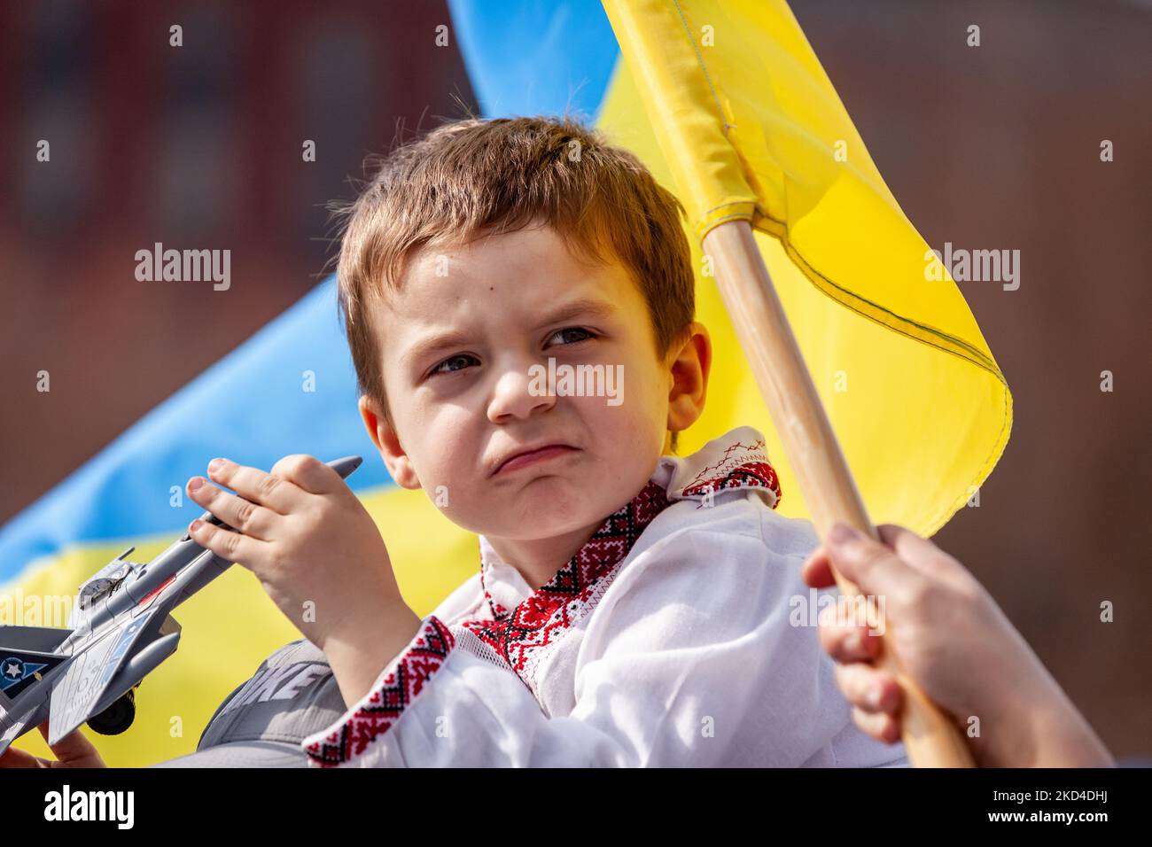 A young protester plays with a toy fighter jet while sitting on his father’s shoulders during a rally at the White House. Thousands of people from across the United States gathered to thank the US and other countries for their help, and to demand a no-fly zone and other assistance for Ukraine. The event was sponsored by United Help Ukraine and US Ukrainian Activists, both U.S.-based assistance and advocacy organizations. (Photo by Allison Bailey/NurPhoto) Stock Photo
