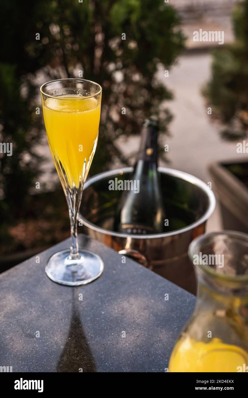 Glasses of mimosas with the bottle of champagne in the back in an ice bucket Stock Photo