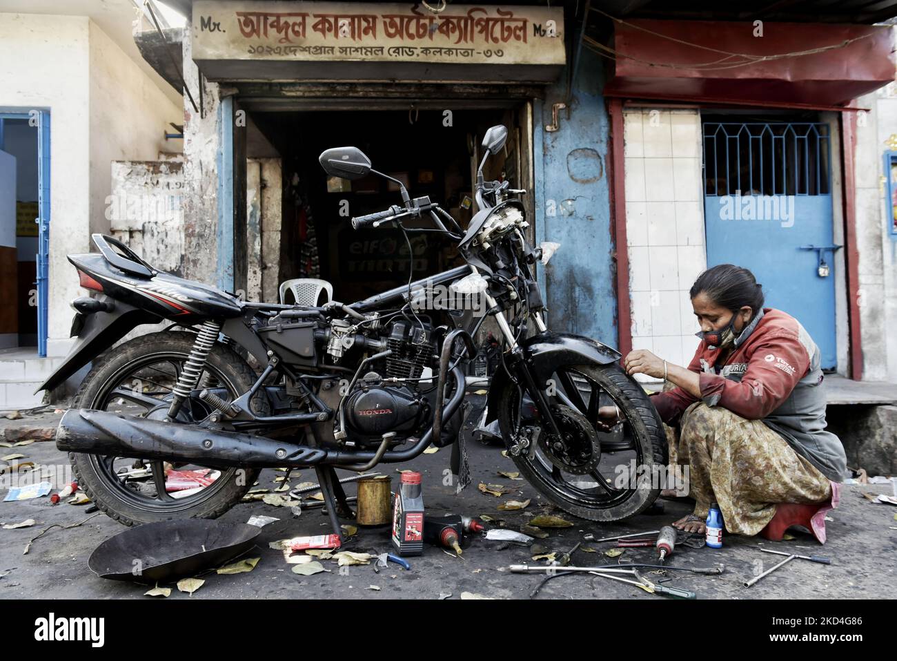 Sonali Mistri, age 51, only woman two wheeler mechanic of Kolkata, works in her garage before the day of International Women's Day, Kolkata, India, 07 March, 2022. (Photo by Indranil Aditya/NurPhoto) Stock Photo