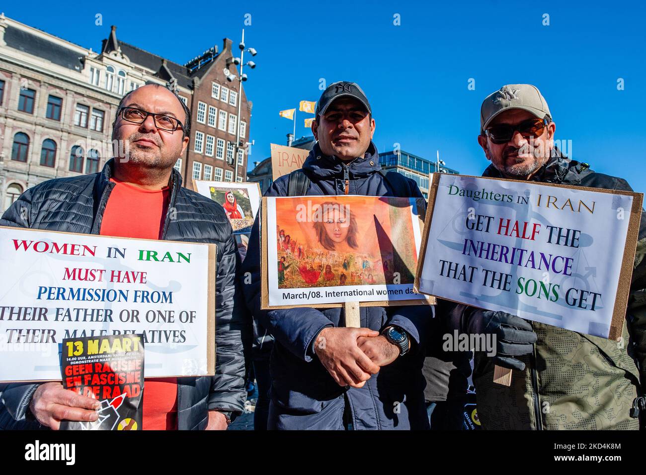 A group of Iranian men is holding placards against the violations of