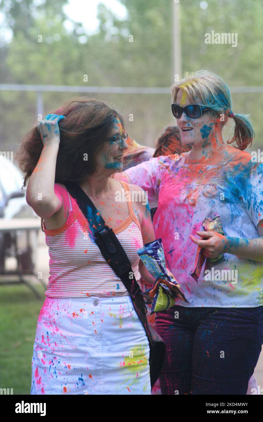 Caucasian youth covered in colour celebrate during the Hindu festival