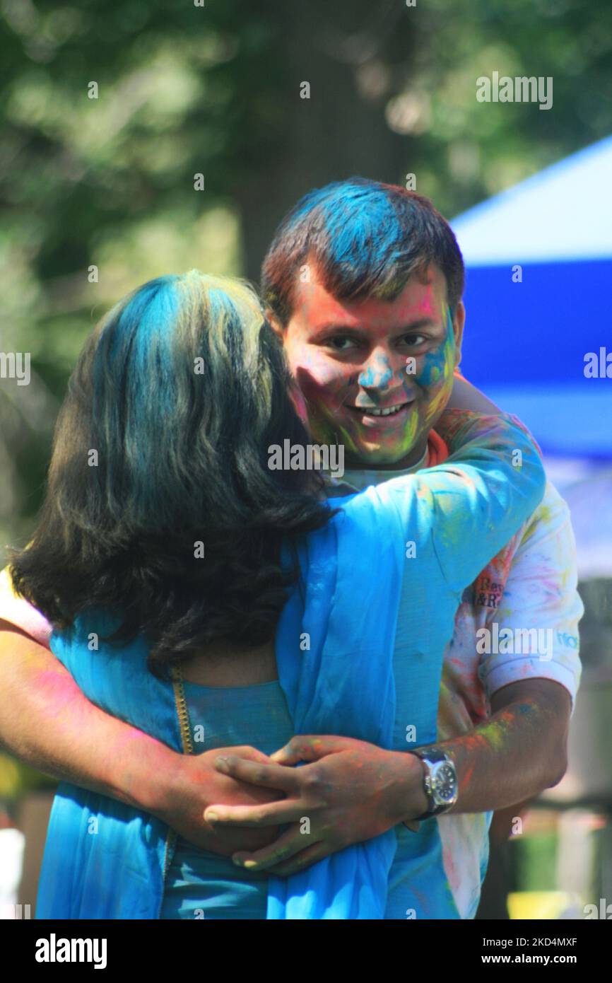 South Asian youth covered in colour celebrate during the Hindu festival