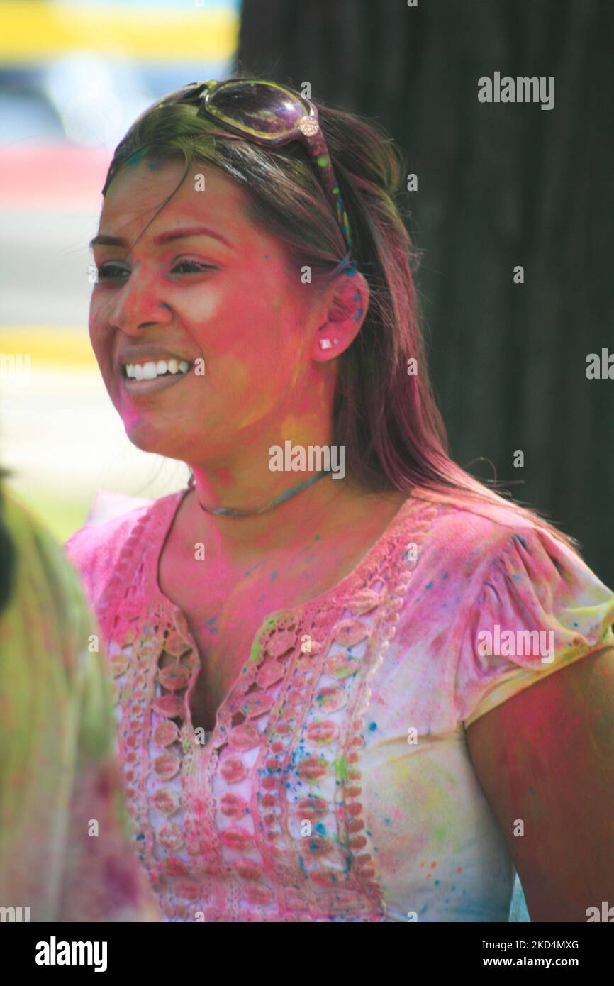 South Asian youth covered in colour celebrate during the Hindu festival