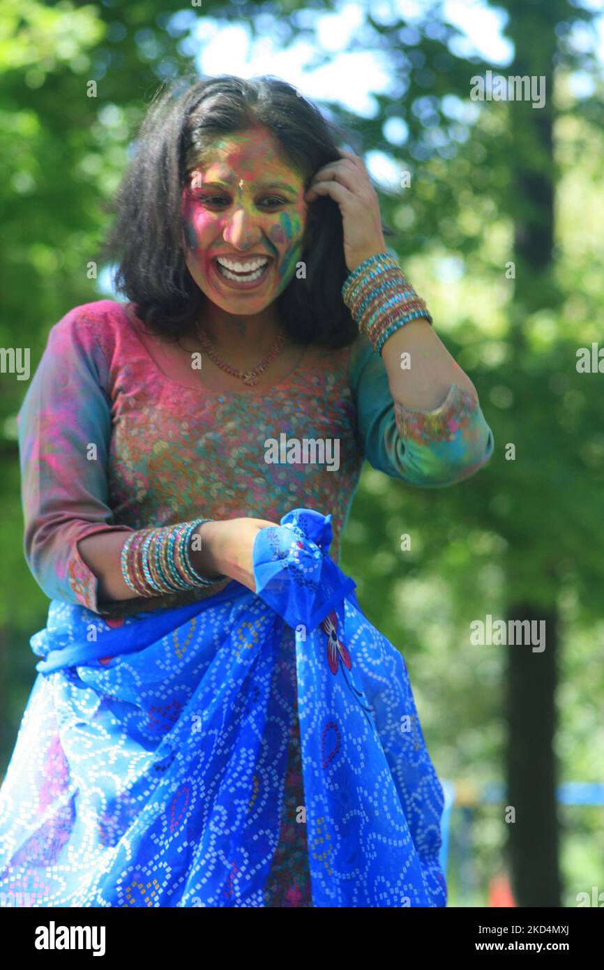 South Asian youth covered in colour celebrate during the Hindu festival