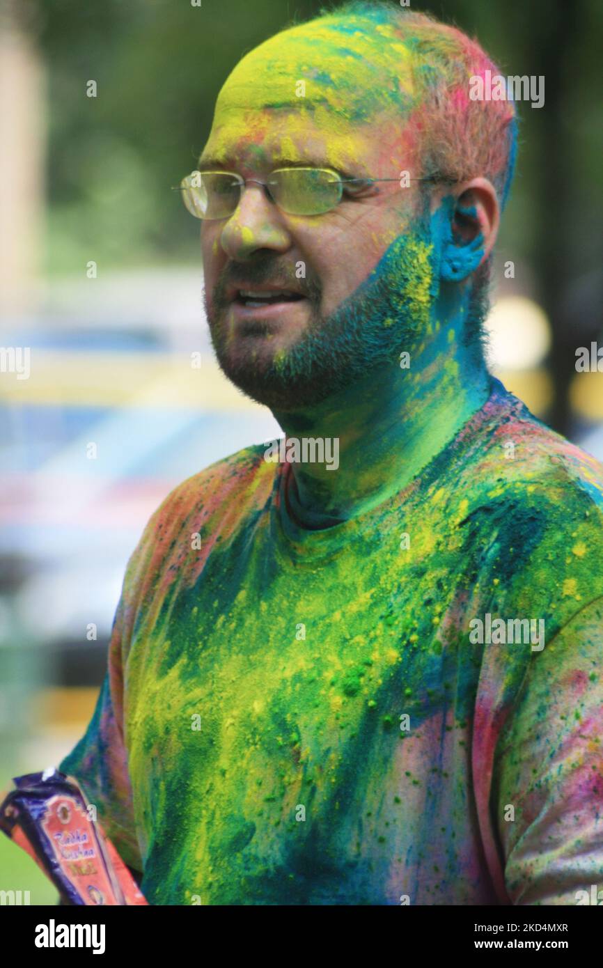 Caucasian man covered in colour during the Hindu festival of Holi in