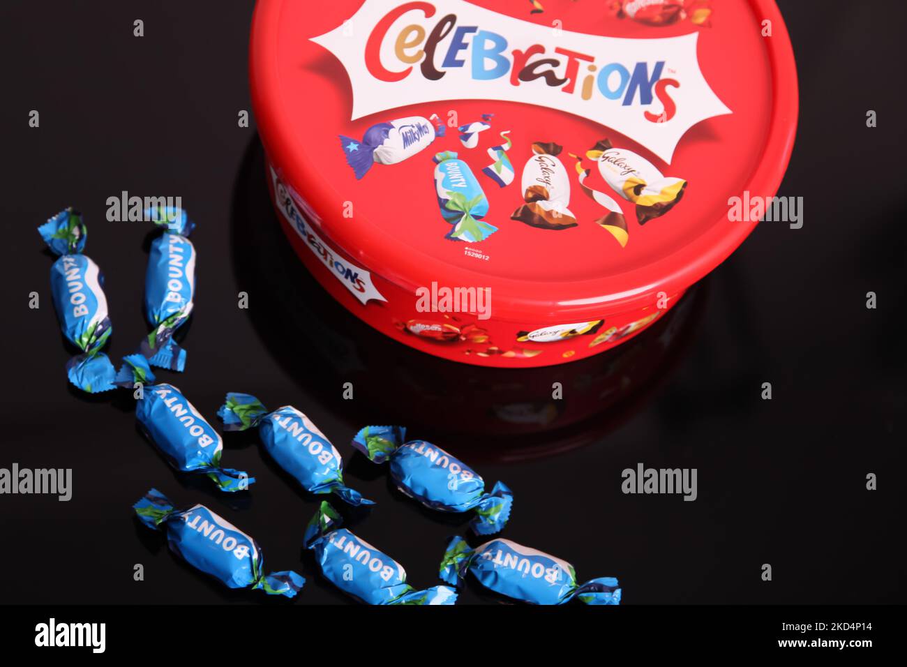 Celebration Bounty chocolate bar outside a tub of Celebrations 2022, removed, left out Stock Photo