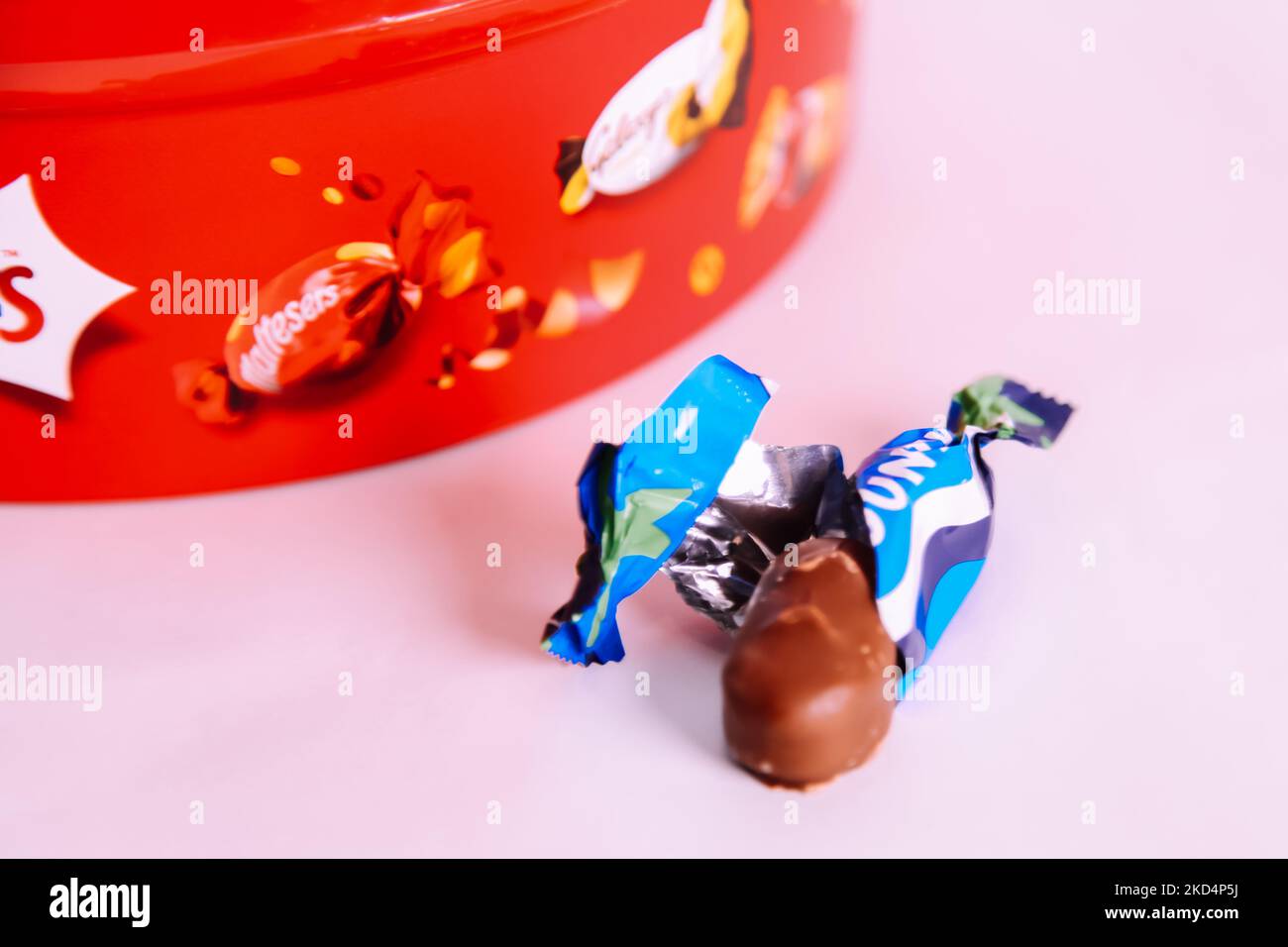 Plastic tub of Celebrations chocolate treat sweets 2022 Christmas edition - Bounty coconut chocolate bar sweet left out Stock Photo