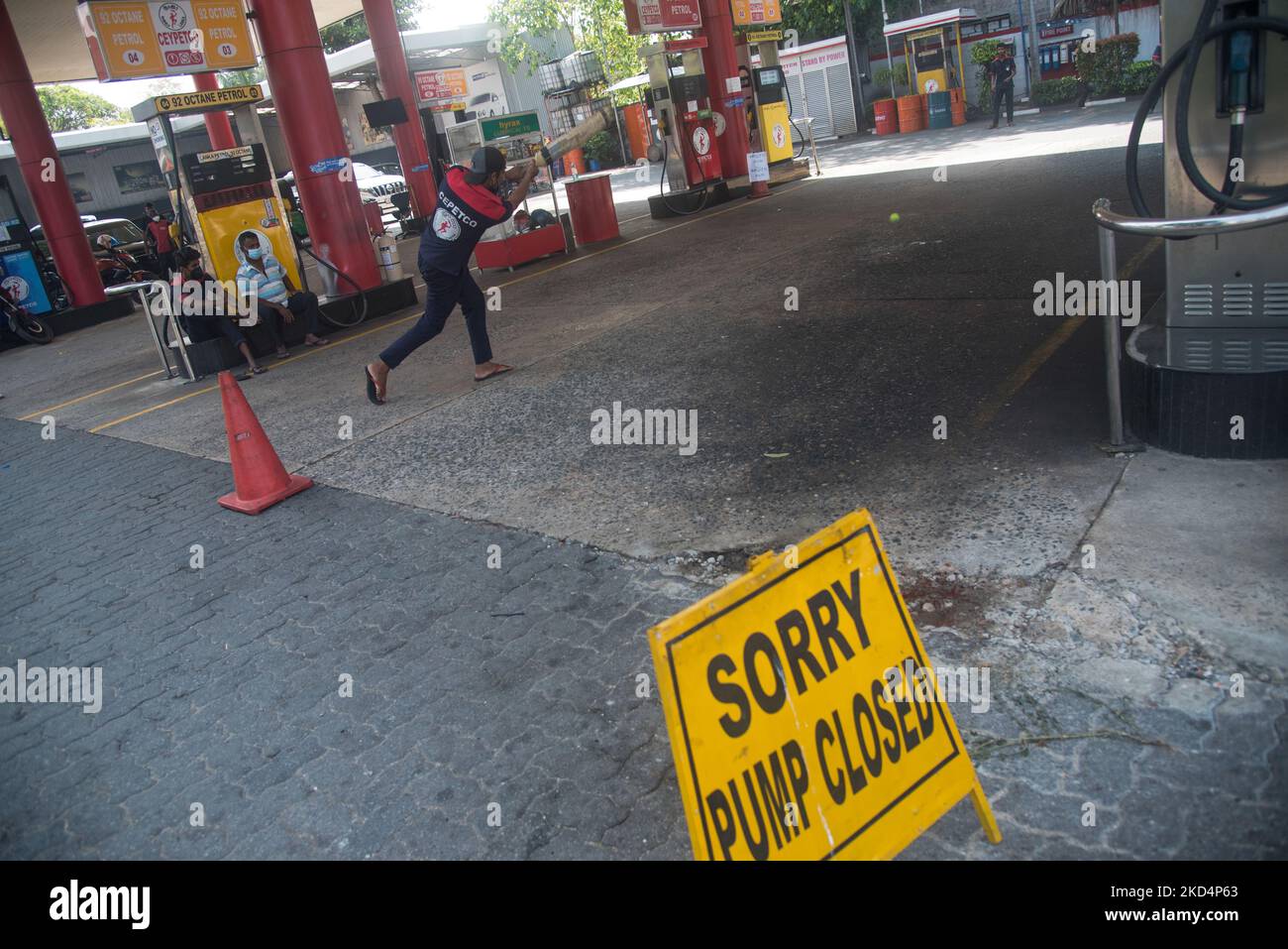 Fuel station workers play cricket after closing down their station