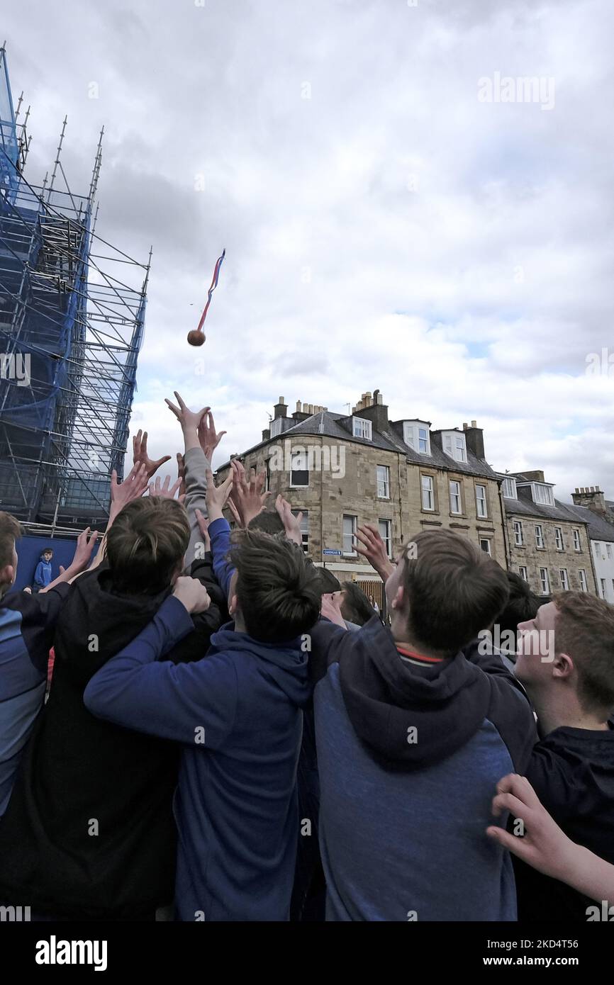 Jedburgh, Thursday 10 March 2022. Youths challenge for the â€œhailedâ€ â€œBaâ€ during the annual 'Fastern Eve Handba' event in Jedburgh's High Street in the Scottish Borders on March 10, 2022 in Jedburgh, Scotland. The annual event, which started in the 1700's, takes place today and involves two teams, the Uppies (residents from the higher part of Jedburgh) and the Doonies (residents from the lower part of Jedburgh) getting the ball to either the top or bottom of the town. The ball, which is made of leather, stuffed with straw and decorated with ribbons is thrown into the crowd to begin the  Stock Photo