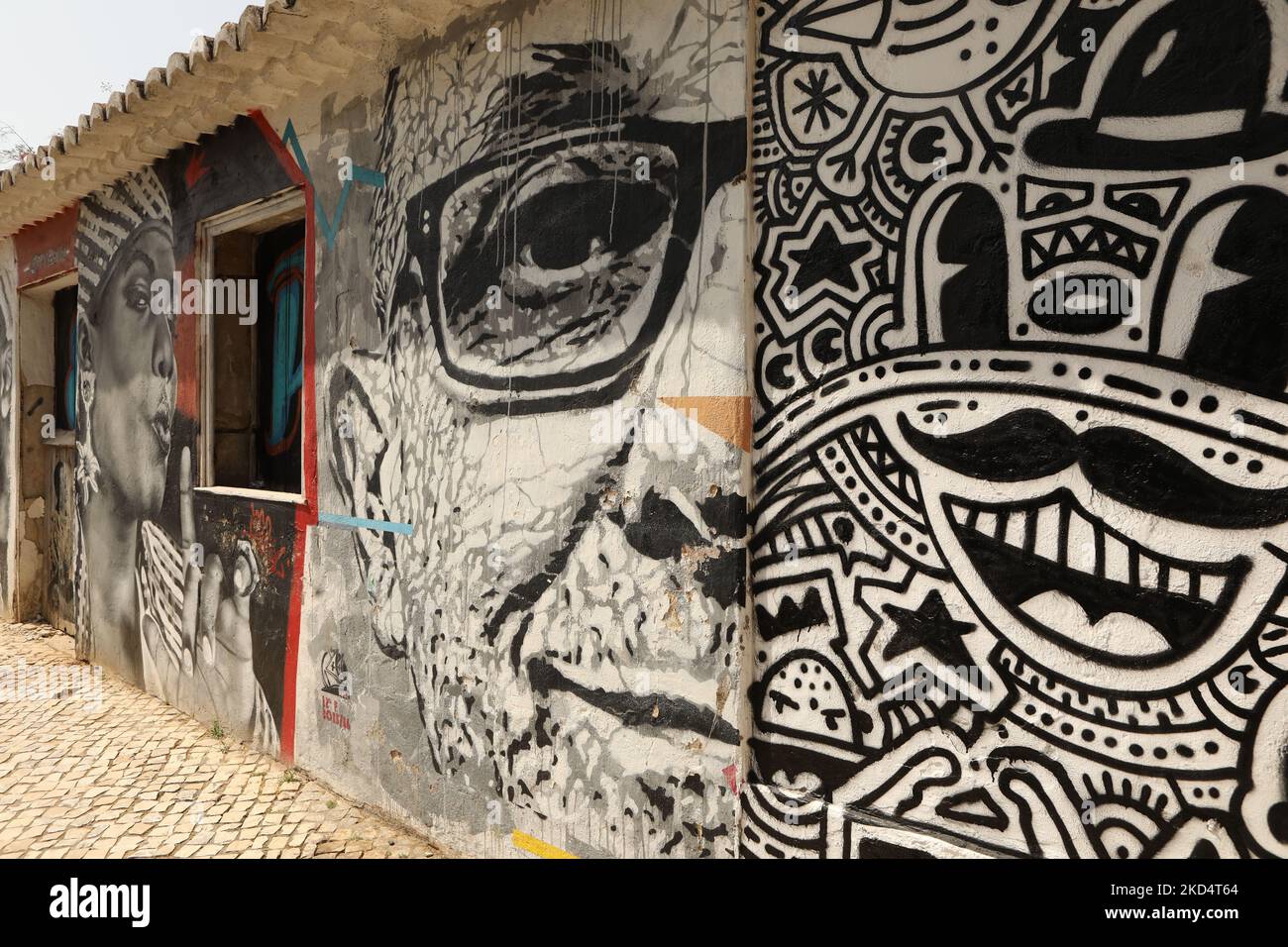 Street Art. A mural of a man wearing spectacles and a pop art mural. Lagos, Algarve, Portugal Stock Photo