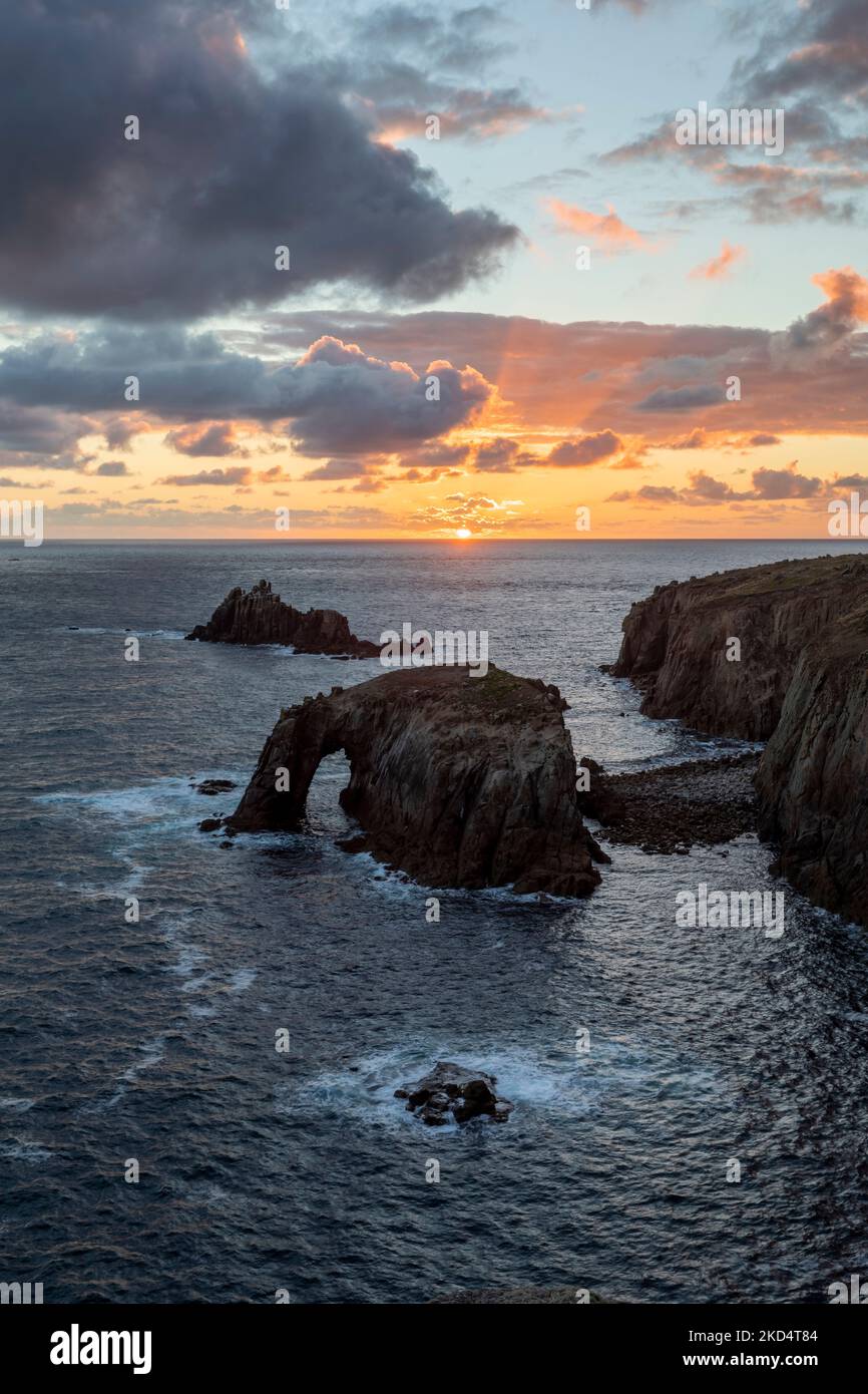 sunset at lands end cornwall with enys dodnan and the armed knight rock formations vert format Stock Photo