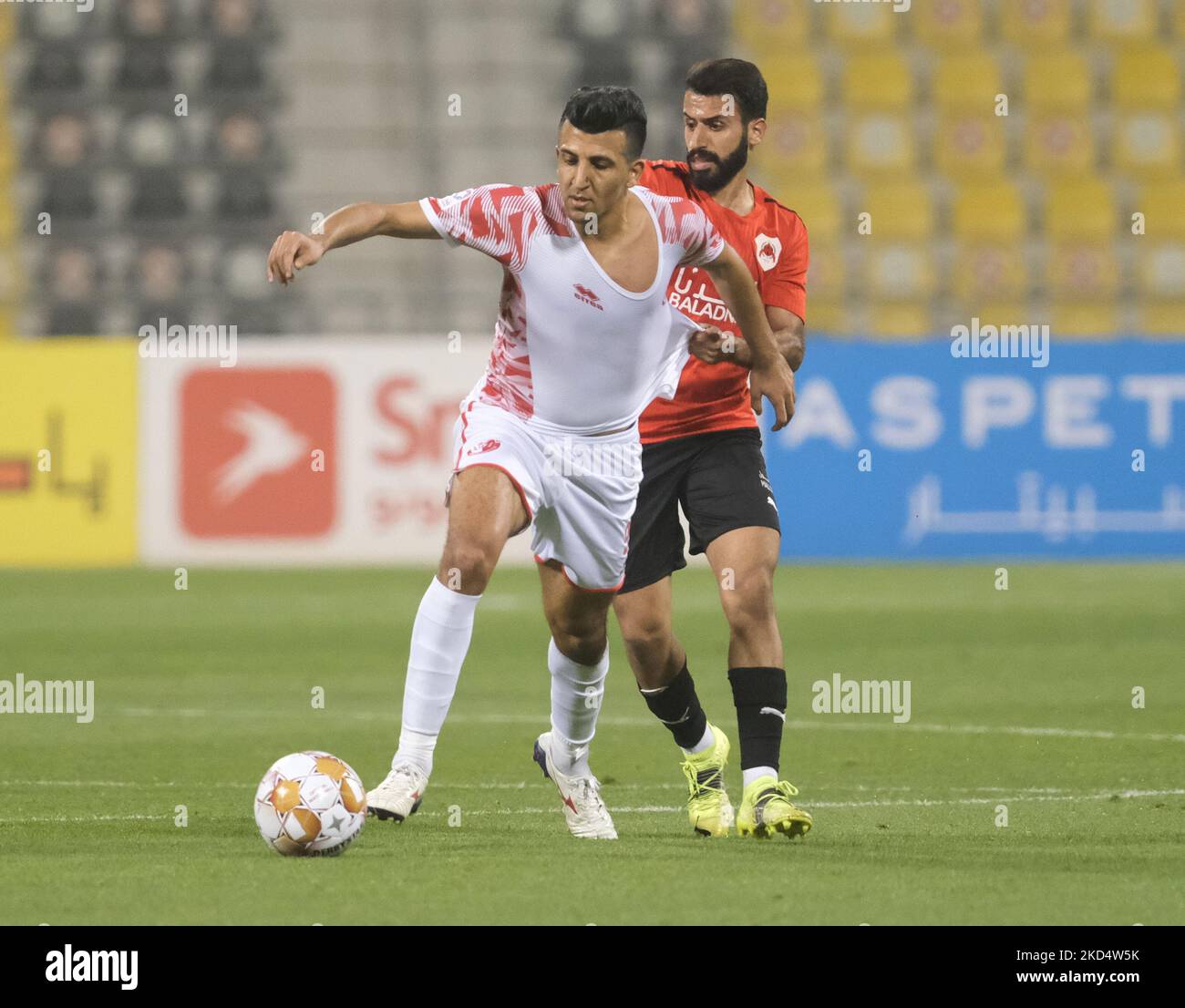 Osamah Al Tairi (16) of Al Rayyan fouls Amjad Attwan (99) of Al Shamal 