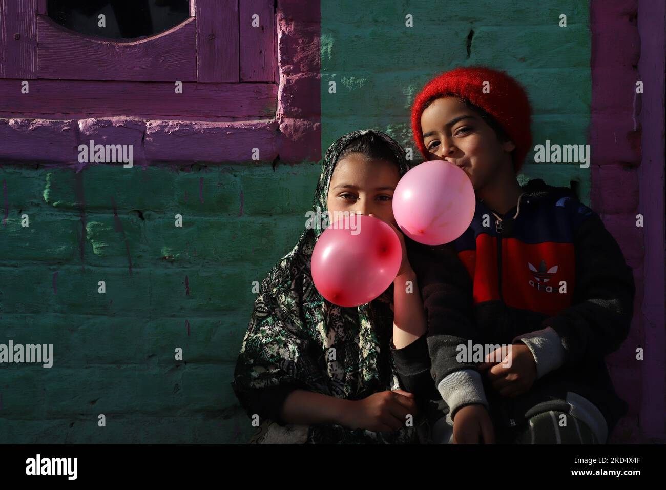 Misba And Sobia fills air in the balloon as they sit at their residence in a far flung Area of Kupwara Jammu and Kashmir India on 12 March 2022 (Photo by Nasir Kachroo/NurPhoto) Stock Photo