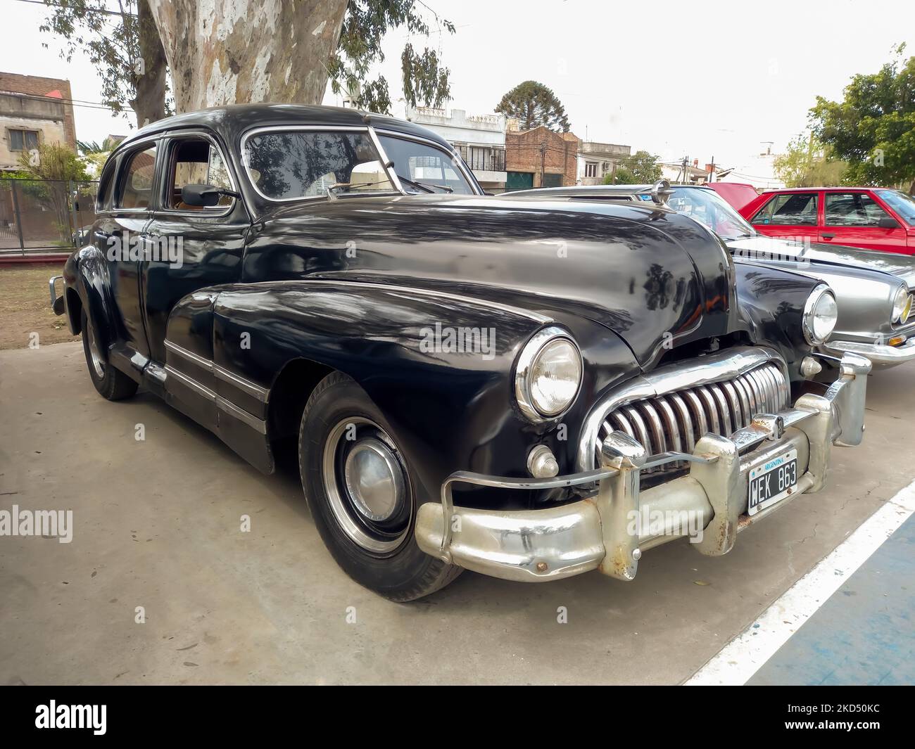 Old black 1940s Buick Eight Special four door sedan by GM in a park. AAA 2022 classic car show. Stock Photo