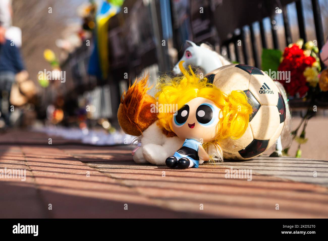 Toys and flowers sit at a memorial during a vigil at the White