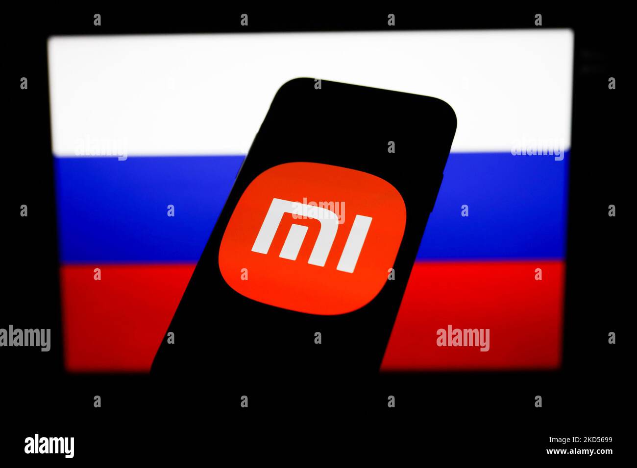 Xiaomi logo displayed on a phone screen and Russian flag displayed on a ...