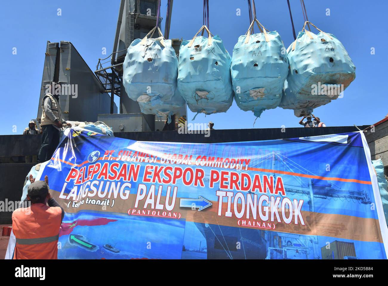 Workers work on the process of transporting coconuts onto ships for direct export from Palu City to China at Pantoloan Port in Palu City, Central Sulawesi Province, Thursday (17/3/2022). PT Sulawesi Global Commodity exports 3,000 tons of coconuts from Central Sulawesi to China and is targeted to continue to increase to reach 10,000 tons every month. (Photo by Mohamad Hamzah/NurPhoto) Stock Photo