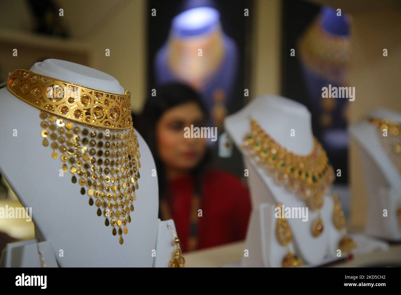A visitor looks at jewellery ornaments on display at a stall at the