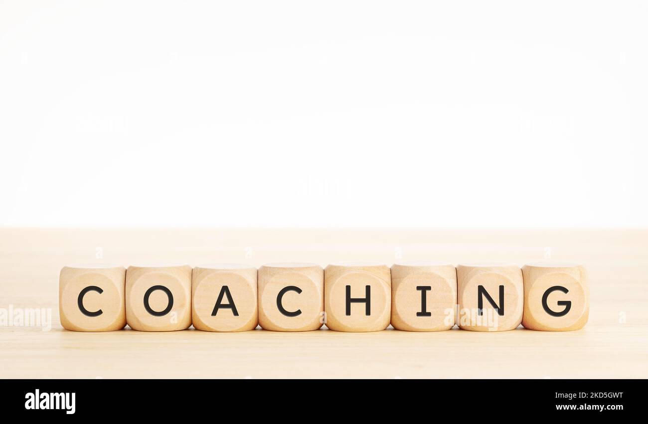 Coaching word on wooden blocks. Copy space Stock Photo