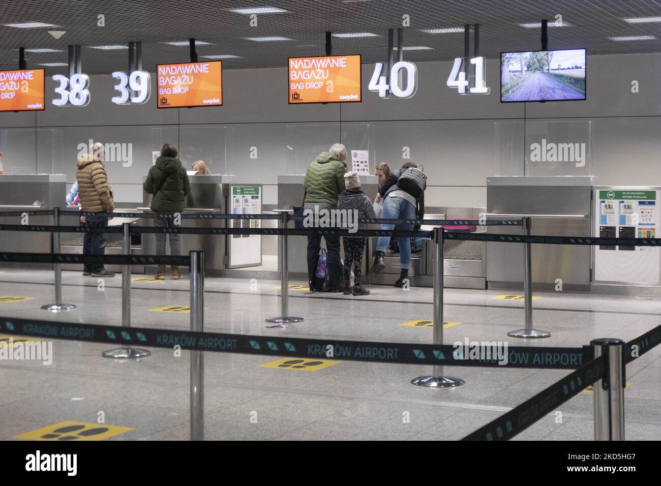 People at the check in desk for EasyJet low cost airline deliver their
