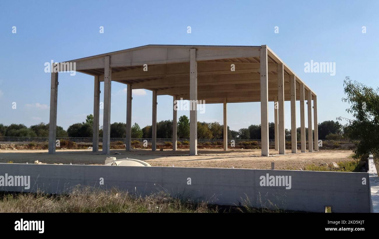 An empty workshop construction with columns without wall panels under a ...