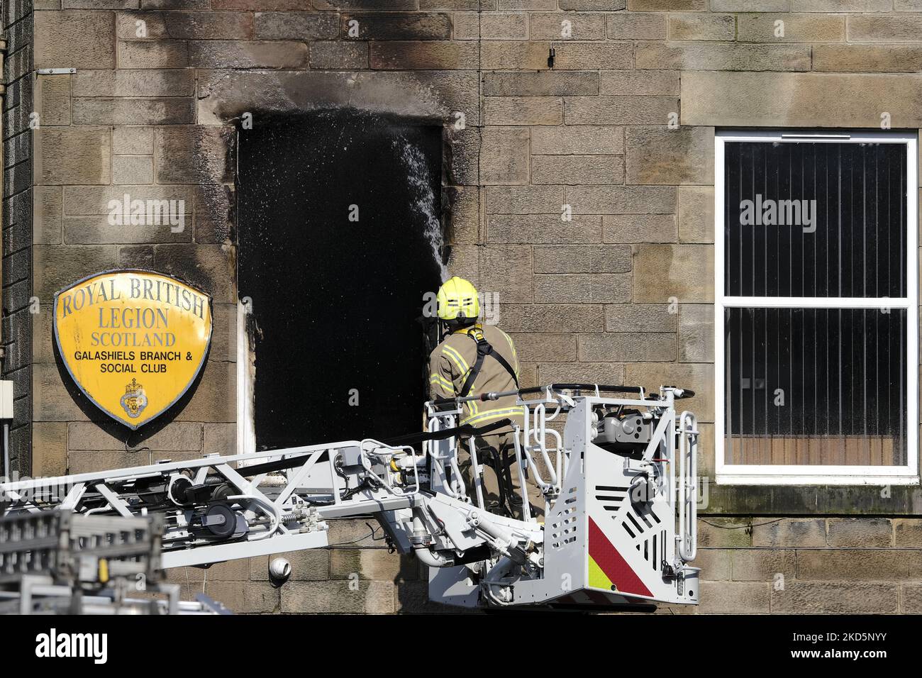 A firefighter on an elevated platform working at a fire at the Royal British Legion in Park Street, Galashiels on Monday 21 March 2022. Fire Scotland attended with four pumps and an elevated access platform to deal with the blaze in the 2 storey building in the centre of town (Photo by Rob Gray/NurPhoto) Stock Photo
