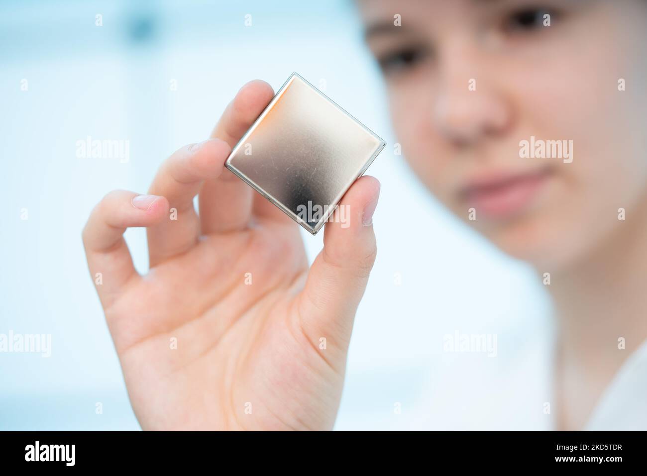 girl holds a hybrid assembly of semiconductor elements to control military drones Stock Photo