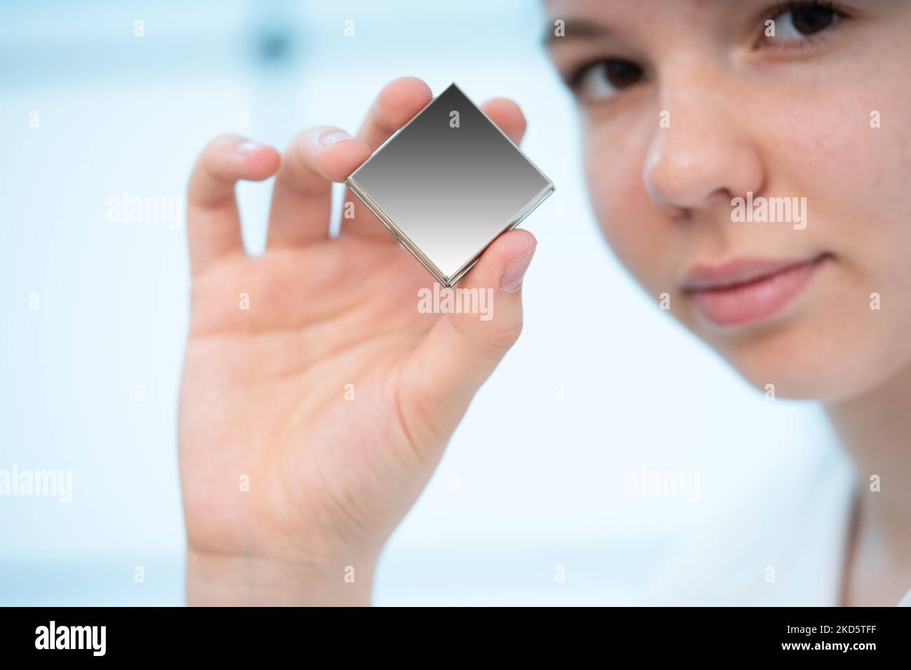 girl holds in her hands an integrated circuit of the global orientation system for the space industry the use of artificial earth satellites Stock Photo