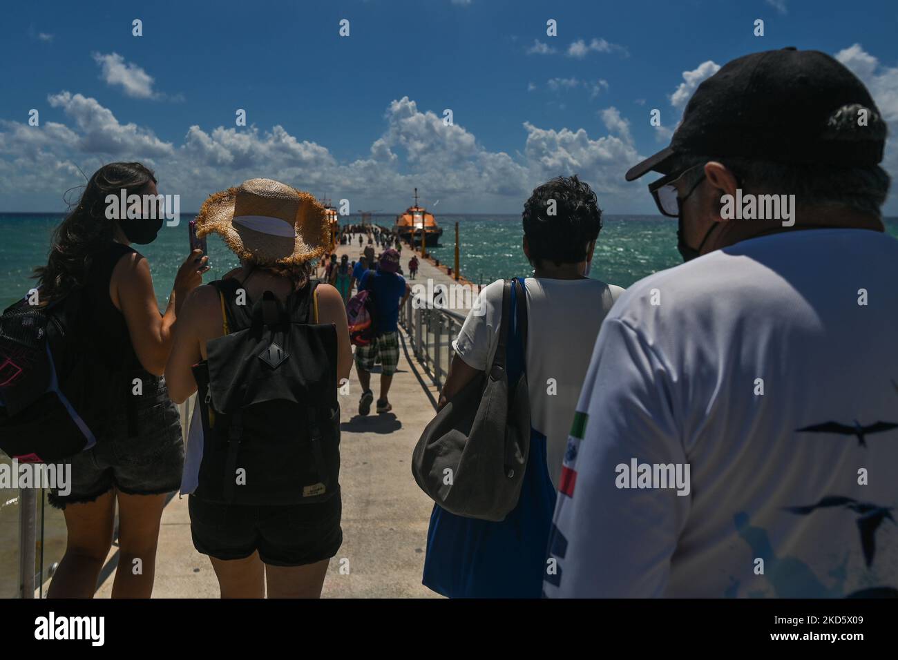 Passengers arrive at the Playa del Carmen ferry terminal to board the